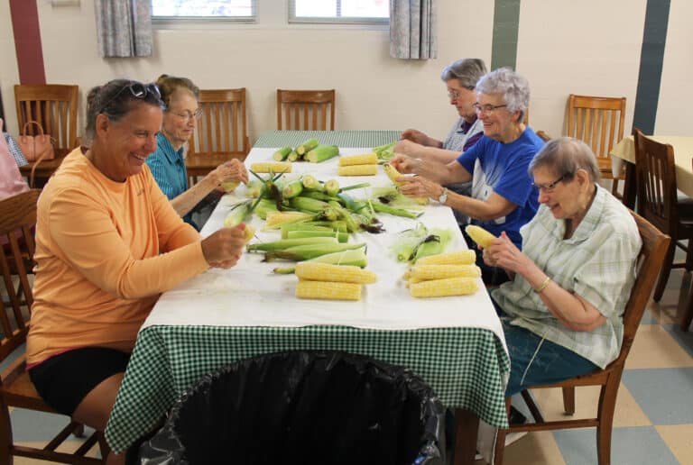 Ursuline Associate Tina Wolken, left, works the shucking line with the Ursuline Sisters. Clockwise from left are Sisters Claudia Hayden, Rose Jean Powers, Ann Patrice Cecil and Susanne Bauer.