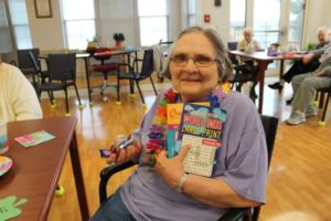 Sister Lois Lindle shows off her word puzzles and candy that she won from the drawing!