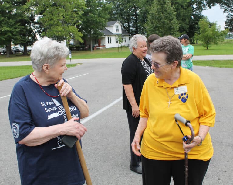 Sister Sharon Sullivan, right, congregational leader of the Ursuline Sisters, talks with Mary Pierce, whose grandson is the lone high school student this year at St. Paul. He is attending an online Catholic high school, but has space reserved in a classroom at St. Paul to do his homework. In back is Sister Martha Keller.