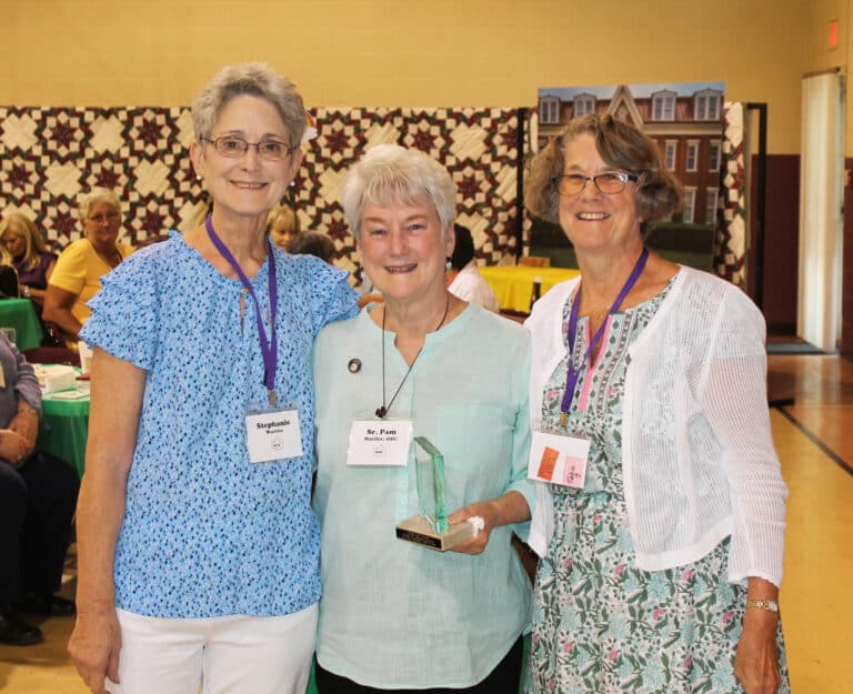 : Sister Pam Mueller A’68, center, accepts her Maple Leaf Award from Stephanie Warren, left, Alumnae Association president, and Carole Caummisar Sanders, her classmate and nominator.