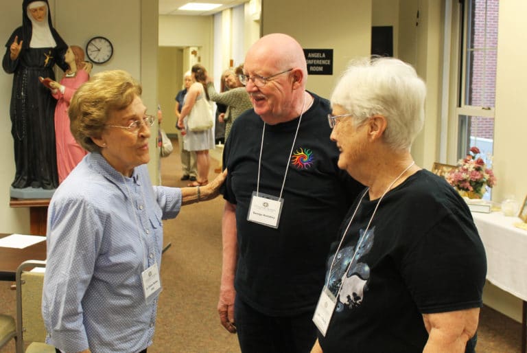 Sister Elaine Burke, left, visits with Memphis Associates George and Lorna Horishny in the morning.