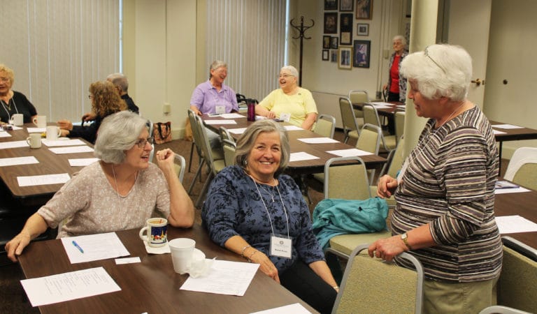Ursuline Associate Pauline Goebel, left, and new Associate Marian Pusey, center, both of Louisville, share a laugh with Owensboro Associate Marian Bennett.