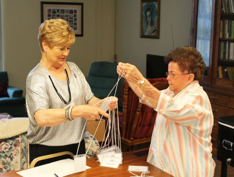 Ursuline Associates Carol Hill, left, of Leitchfield, Ky., and Phyllis Troutman, of Raywick, Ky., realized “what a tangled web we weave” when trying to sort out name tags during the registration process.