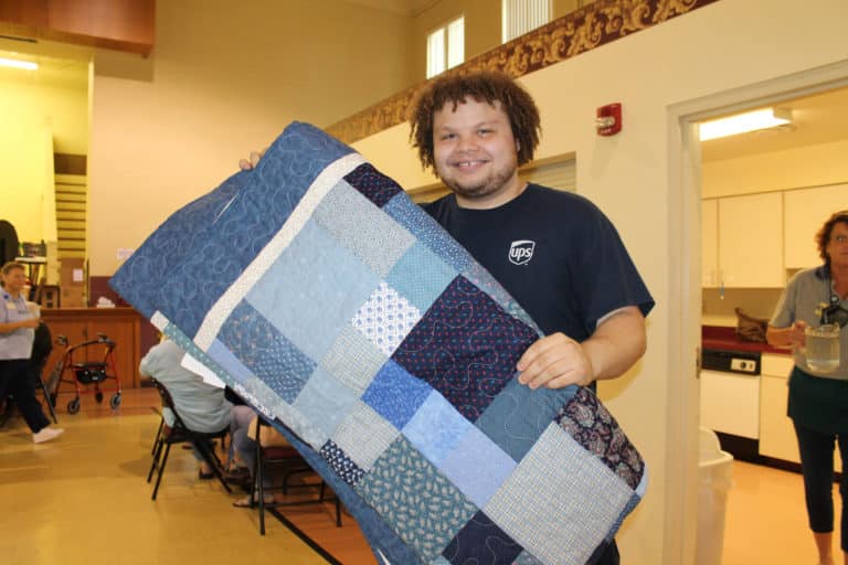 Lance Price of Louisville takes home this beautiful blue quilt.