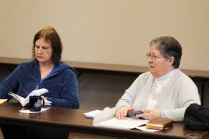 Louise Elpers, right, makes a point about how many references of language from the Second Vatican Council are included in the book, as Judy King pages through her copy.