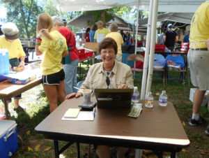 Sister Margaret Ann Aull smiles as she takes care of the money in the barbecue Sandwich and Burgoo by the Cup booth. Photo taken by Ursuline Associate Mary Danhauer.