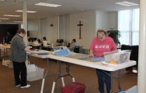 Sister Amelia and Cindy Wilson from Memphis are busy cutting fabric