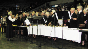 More than 50 Ursuline Sisters of Mount Saint Joseph – more than a third of all the sisters – attended the 75th anniversary Mass for the Diocese of Owensboro on Dec. 8, 2012, in the Owensboro Sportscenter. Sister Fran Wilhelm leads the sisters in singing the “Magnificat” to begin Mass.