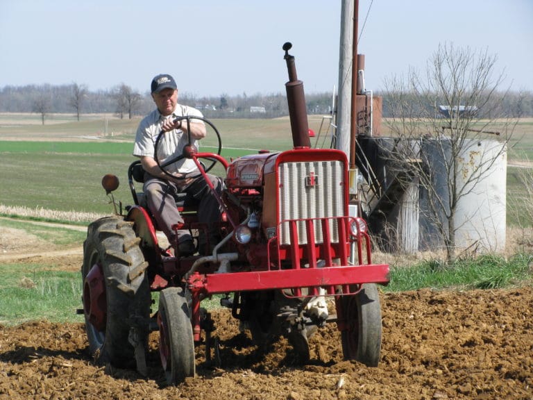 Mark Blandford plants potatoes in 2010, the year after he became farm manager.