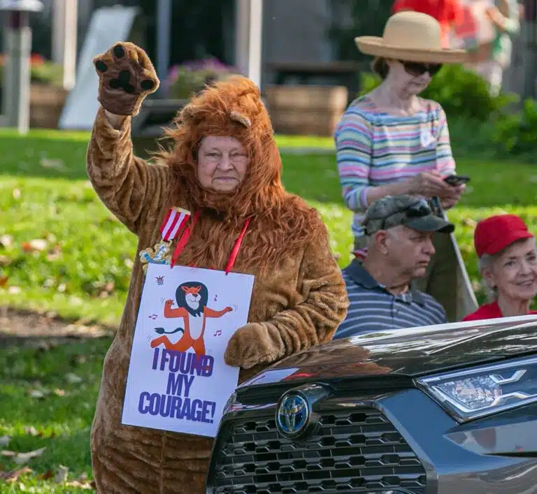 Ursuline Associate Mary Danhauer dons her cowardly lion costume and tells people 