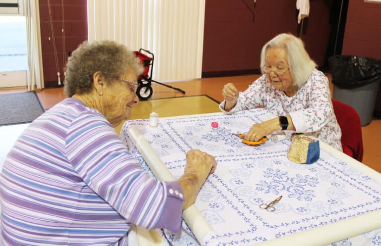 Ursuline Associate Mary Teder, left, quilts with June Cole, of Bowling Green, Ky., who was attending her first Quilting Friends.