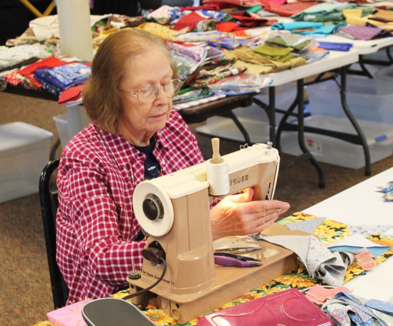 Merline Long, of Louisville, works on quilt blocks with her Singer sewing machine on Feb. 25.