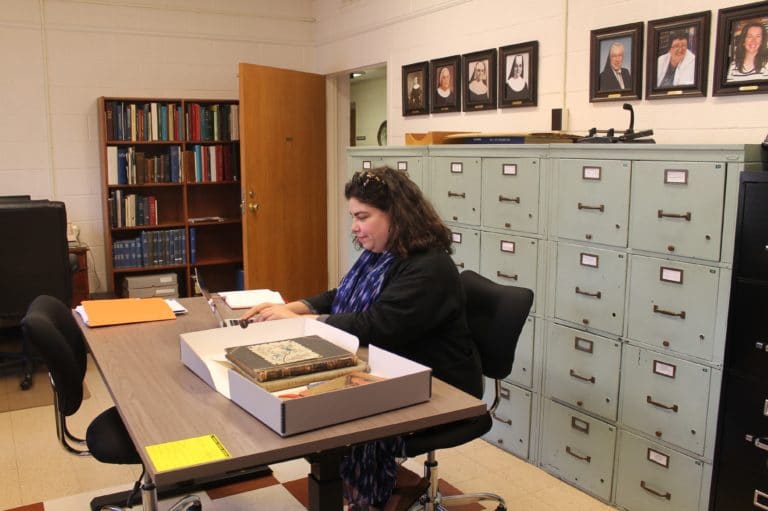 Monica Mercado, who is writing a book about Catholic girl’s education prior to 1911, looks through materials in the archives at Maple Mount, Ky. She said she enjoyed seeing the former Academy (now the Mount Saint Joseph Conference and Retreat Center), the Guest House, and the cemetery.