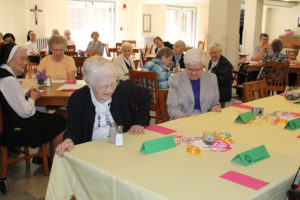 Jubilarians Sister Mary Irene Cecil, left, and Sister George Mary Hagan get ready to take their place at the beginning of the buffet line.