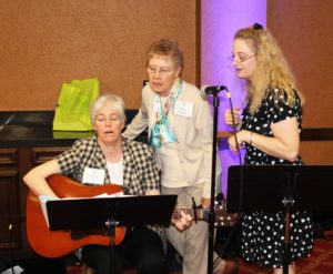 Sister Nancy Liddy of Mount Saint Joseph, left, and Sister Margie Efkeman, center, of Cincinnati, practice songs for the opening prayer service with Lisa Feldcamp, a cantor from Louisville who helped with all the prayer services. Laura Meyer, a music director in Louisville, played the organ at all the services.