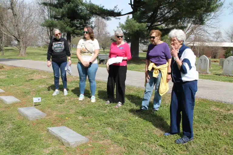 Left to right, Debbie McCoy, president of the Owensboro AAUW, Sagan Storm, Judy Adams, Aloma Dew and Sister Elaine Burke discuss which graves to place a flag honoring an Ursuline Sister.