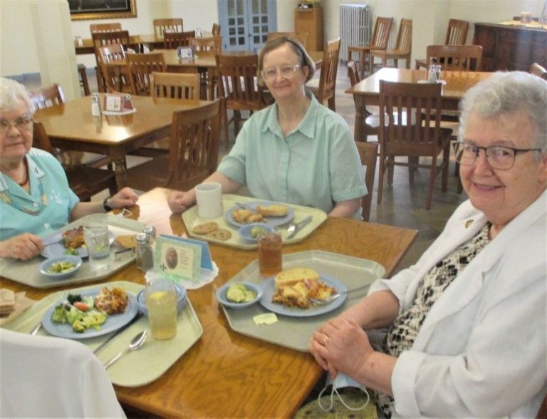Sister Michele Morek, right, Sister Rebecca White, center, and Sister Cecelia Joseph Olinger sit down for a hearty meal.