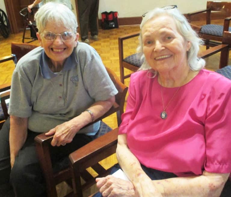 Sister Mary Celine Weidenbenner, left, and Sister Pat Rhoten are all smiles as they gather in the chapel. The two entered the community together in 1963, and will celebrate their 60th jubilees next year.