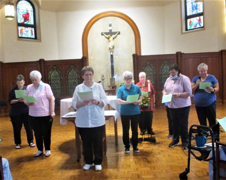 The outgoing and incoming Leadership Councils prepare for the Commissioning Ceremony, when the Sisters receive their ministry assignments and prayer partners for the coming year. From left are Sisters Sharon Sullivan, Pat Lynch, Amelia Stenger, Pam Mueller, Ann McGrew, Monica Seaton and Martha Keller. Sister Judith Nell Riney is behind Sister Monica.