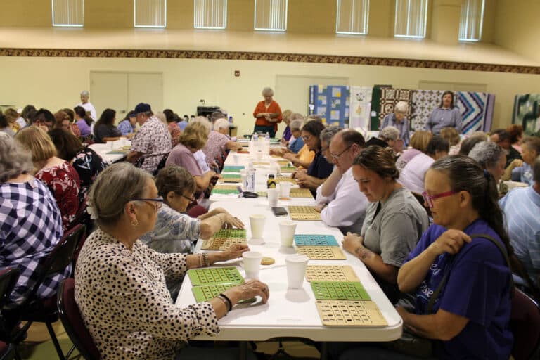 Participants keep an eye on their bingo cards as they play one of 31 games for a chance to win their choice of a variety of quilts.