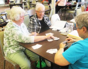 Sister Vivian Bowles, left, prepares to draw a card, as Sister Sara Marie Gomez, center, and Sister Karla Kaelin plot their next move.