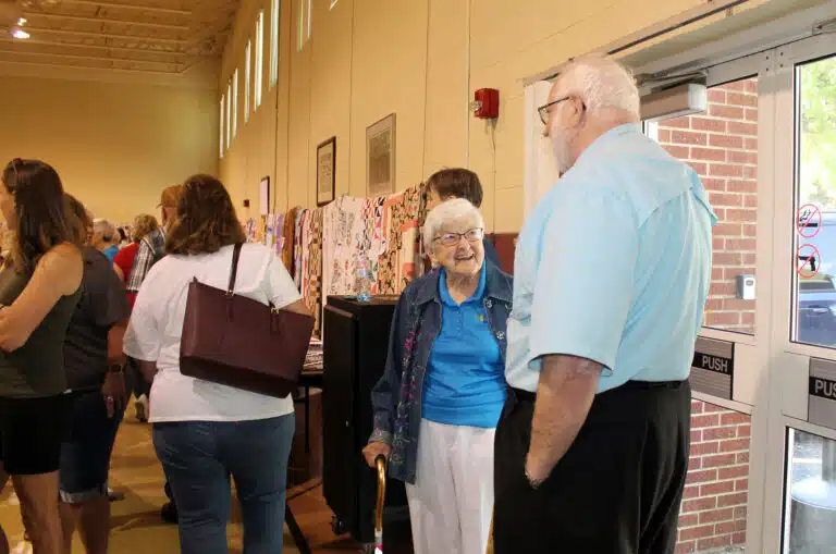 Sister George Mary Hagan greets Father Ray Goetz, the chaplain for the Ursuline Sisters. She was a door greeter for everyone who came in the west side doors. Sister George Mary Hagan greets Father Ray Goetz, the chaplain for the Ursuline Sisters. She was a door greeter for everyone who came in the west side doors.