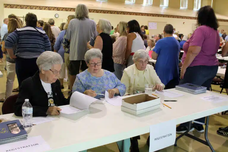 Sisters Nancy Murphy, Mary McDermott, and Julia Head take a moment to check their registration lists near the entrance doors. Sisters Nancy Murphy, Mary McDermott, and Julia Head take a moment to check their registration lists near the entrance doors.