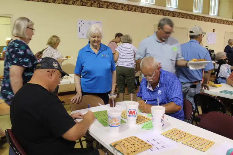 Sister Vivian Bowles smiles as two people at the table where she was volunteering filled out raffle tickets. Sister Vivian Bowles smiles as two people at the table where she was volunteering filled out raffle tickets.