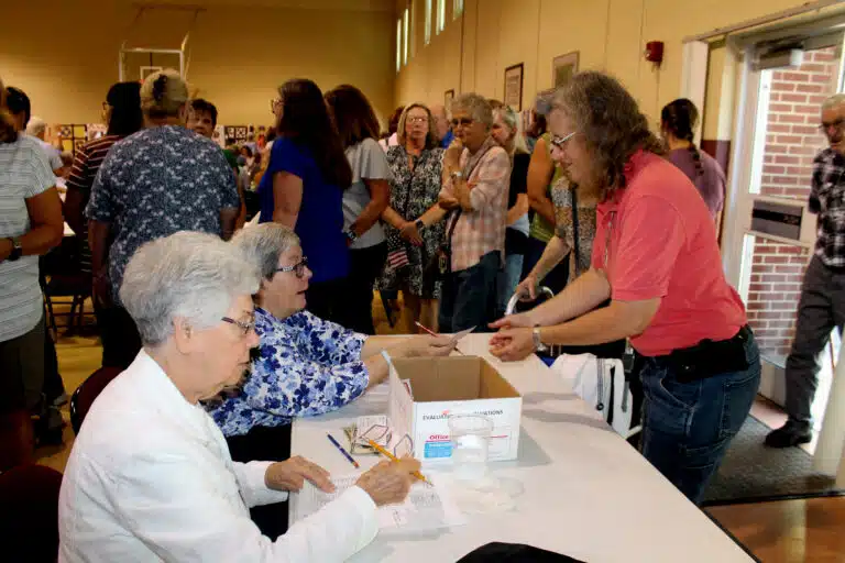 Sister Nancy Murphy, left, and Sister Mary McDermott check attendees’ names off a list as they enter Maple Hall. Sister Nancy Murphy, left, and Sister Mary McDermott check attendees’ names off a list as they enter Maple Hall.