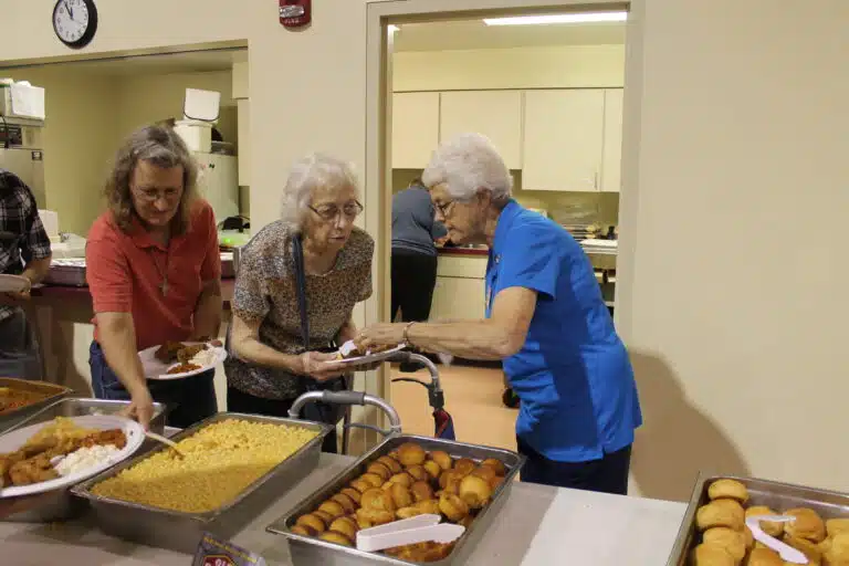 Sister Barbara Jean Head, right, helps a lady with her lunch plate in the serving line. Sister Barbara Jean Head, right, helps a lady with her lunch plate in the serving line.