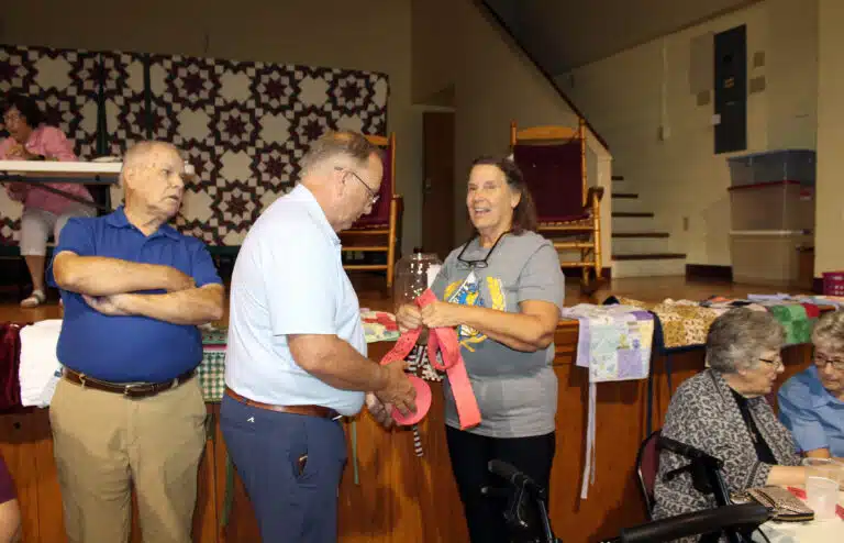 Associate Ed Cecil, left, watches as volunteer Keith Osborne hands half-pot tickets to Associate Tina Wolken. Associate Ed Cecil, left, watches as volunteer Keith Osborne hands half-pot tickets to Associate Tina Wolken.