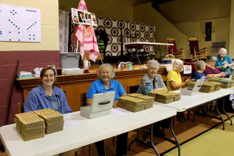 Left to right, Associate Amy Fogle Stiff, Sister Martha Keller and Sister Michele Morek smile as they get ready to sell bingo cards to attendees. Left to right, Associate Amy Fogle Stiff, Sister Martha Keller and Sister Michele Morek smile as they get ready to sell bingo cards to attendees.