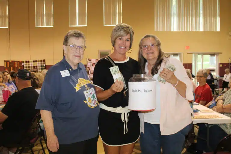 The happy half-pot winner, Nanette Blandford of Owensboro, center, is joined by her mother Janet Howard, right, and Sister Sharon Sullivan, congregational leader. The happy half-pot winner, Nanette Blandford of Owensboro, center, is joined by her mother Janet Howard, right, and Sister Sharon Sullivan, congregational leader.