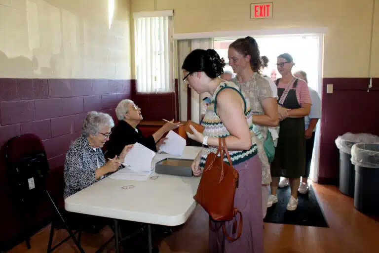 Sister Ann Patrice Cecil, left, and Sister Ann McGrew check in people as they enter Maple Hall. Sister Ann Patrice Cecil, left, and Sister Ann McGrew check in people as they enter Maple Hall.