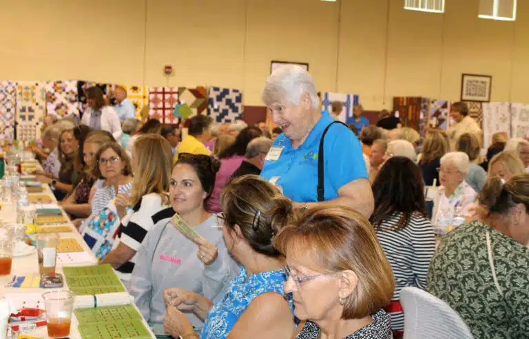 Sister Suzanne Sims smiles as she sells half pot tickets amid the crowd of bingo players. Sister Suzanne Sims smiles as she sells half pot tickets amid the crowd of bingo players.