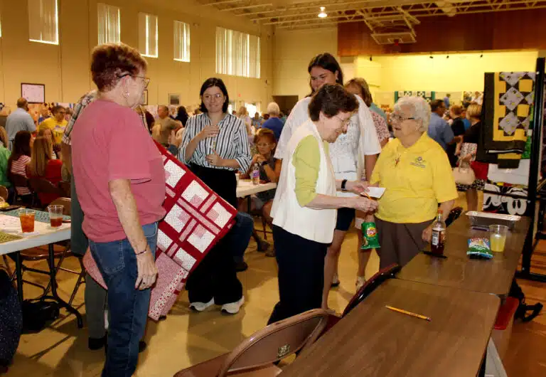 Sister Mary Henning, second from right, and Sister Cecelia Joseph “C.J.” Olinger, right, get the name of one of the quilt winners. Sister Mary Henning, second from right, and Sister Cecelia Joseph “C.J.” Olinger, right, get the name of one of the quilt winners.