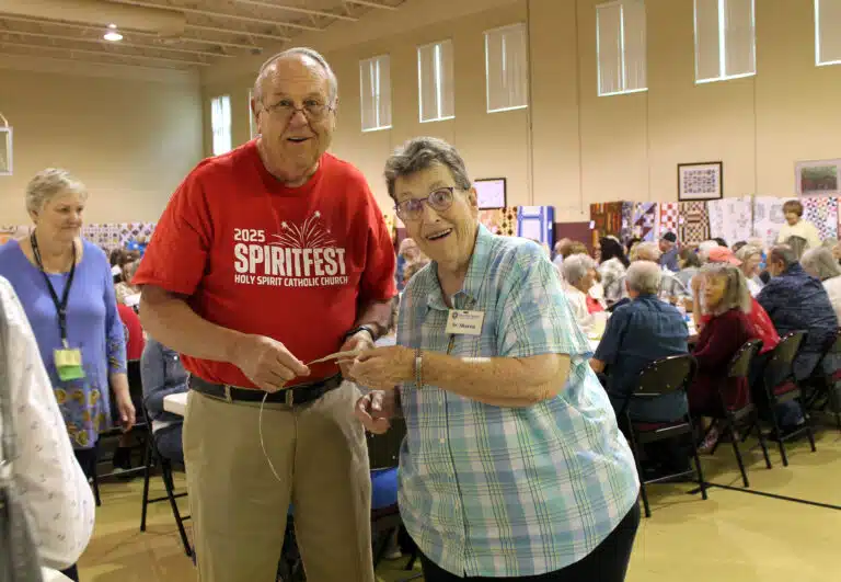 Sister Sharon Sullivan smiles as she takes the winning ticket from half pot winner David Chandler of Bowling Green. Sister Sharon Sullivan smiles as she takes the winning ticket from half pot winner David Chandler of Bowling Green.