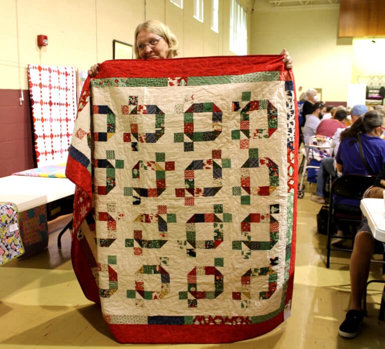 Volunteer Ann Jacobs of Moscow Mills, Mo., ended up winning a game, and she chose this Christmas quilt.