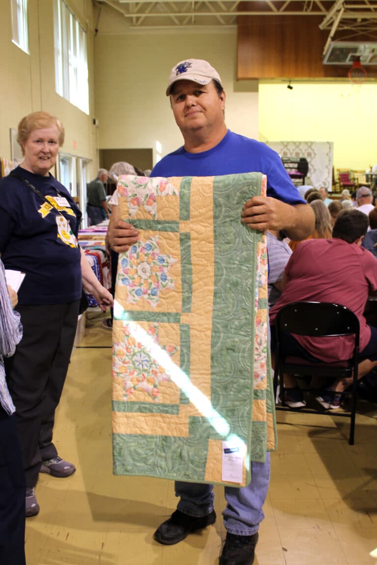 Steve Allan of Hawesville liked the “Terrific Tulips” quilt. Sister Helena Fischer at left helped him pick the quilt.