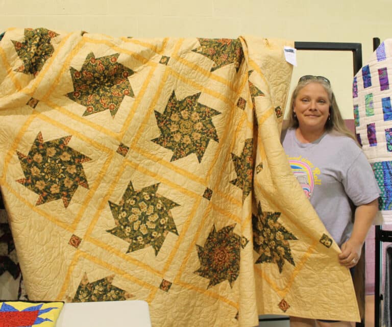 Michelle Morris of Owensboro was the lucky winner of the large “Kaleidoscope” quilt.
