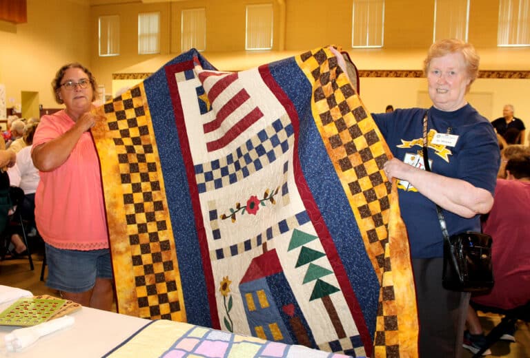 Lisa Clary of Owensboro got to take home the “Welcome to Our House” quilt, which Sister Helena Fischer is helping to hold.