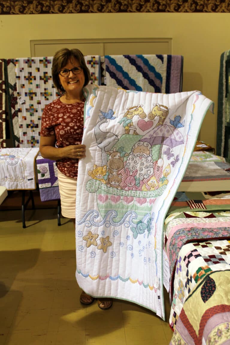 Angie Klump of Owensboro was happy to win this cross-stitched Noah’s Ark baby quilt.
