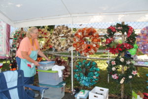 A volunteer helps in the Quilts and Wreaths booth. Almost all of them were sold. The extras will be for sale in the Mount Saint Joseph Gift Shop.
