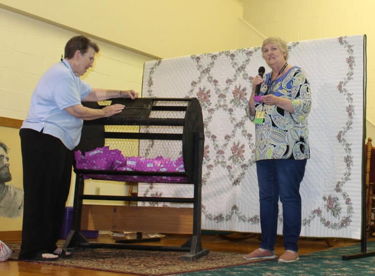 Director of Development Carol Braden-Clarke, right, reads the name of the one of the raffle winners that was handed to her by Sister Sharon Sullivan.