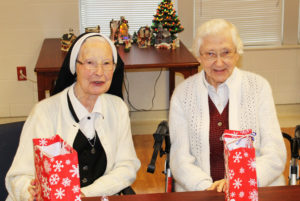 Sister Emerentia Wiesner, left, and Sister Clarita Browning enjoy their goody bags.