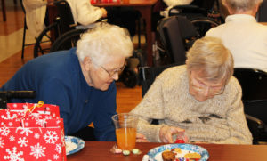 Sister Joan Walz, left, joins Sister Rosalin Thieneman in looking over the LED lighted snowman she received as a present from Santa.