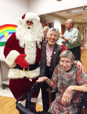 Santa joins Sister Marietta Wethington, center, and Sister Amanda Rose Mahoney for some holiday cheer.