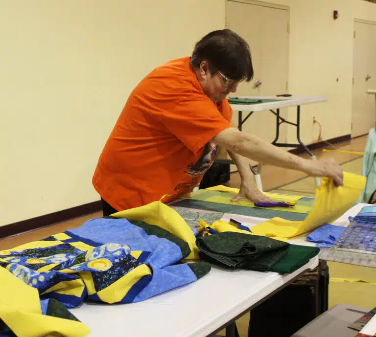 Sally Fitzgerald, of Bowling Green, Ky., cuts the final strips for her Vincent Van Gogh “Starry Night” quilt top. Sally Fitzgerald, of Bowling Green, Ky., cuts the final strips for her Vincent Van Gogh “Starry Night” quilt top.