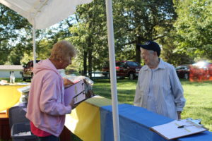 Ursuline Associate Michelle Hayes, left, talks to Sister Michael Ann Monaghan while setting up the Silent Auction booth.