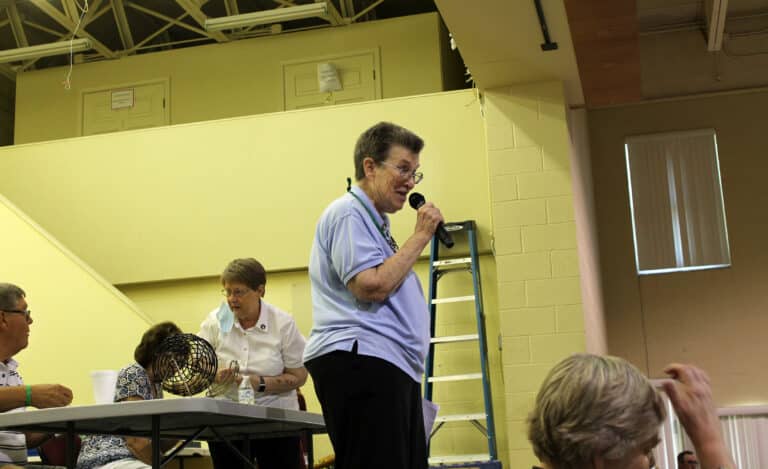 Congregational Leader Sister Sharon Sullivan makes welcoming remarks as the crowd gets ready to play Quilt Bingo. She said there were definitely more than “two or three gathered in my name,” referring to the well-known Bible verse.